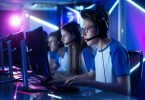 Team of Teenage Gamers Play in Multiplayer PC Video Game on a eSport Tournament. Captain Gives Commands into Microphone, Trying Strategically Win the Game.